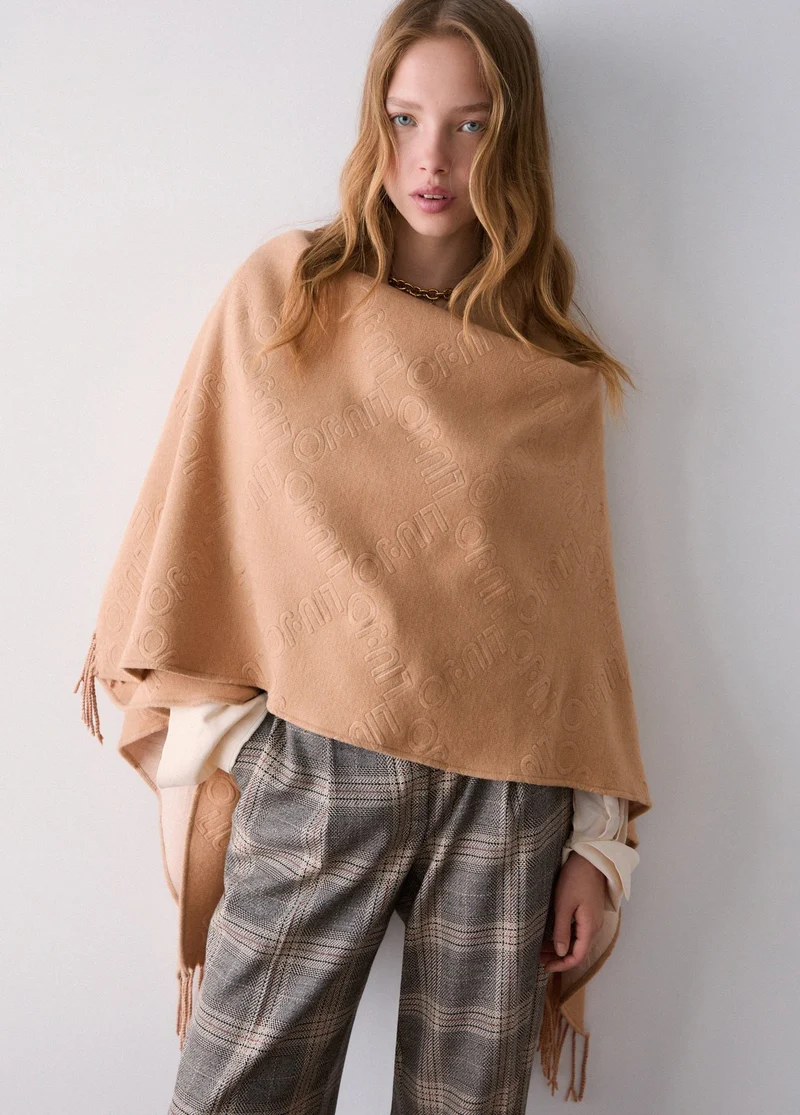 Poncho with embossed logo