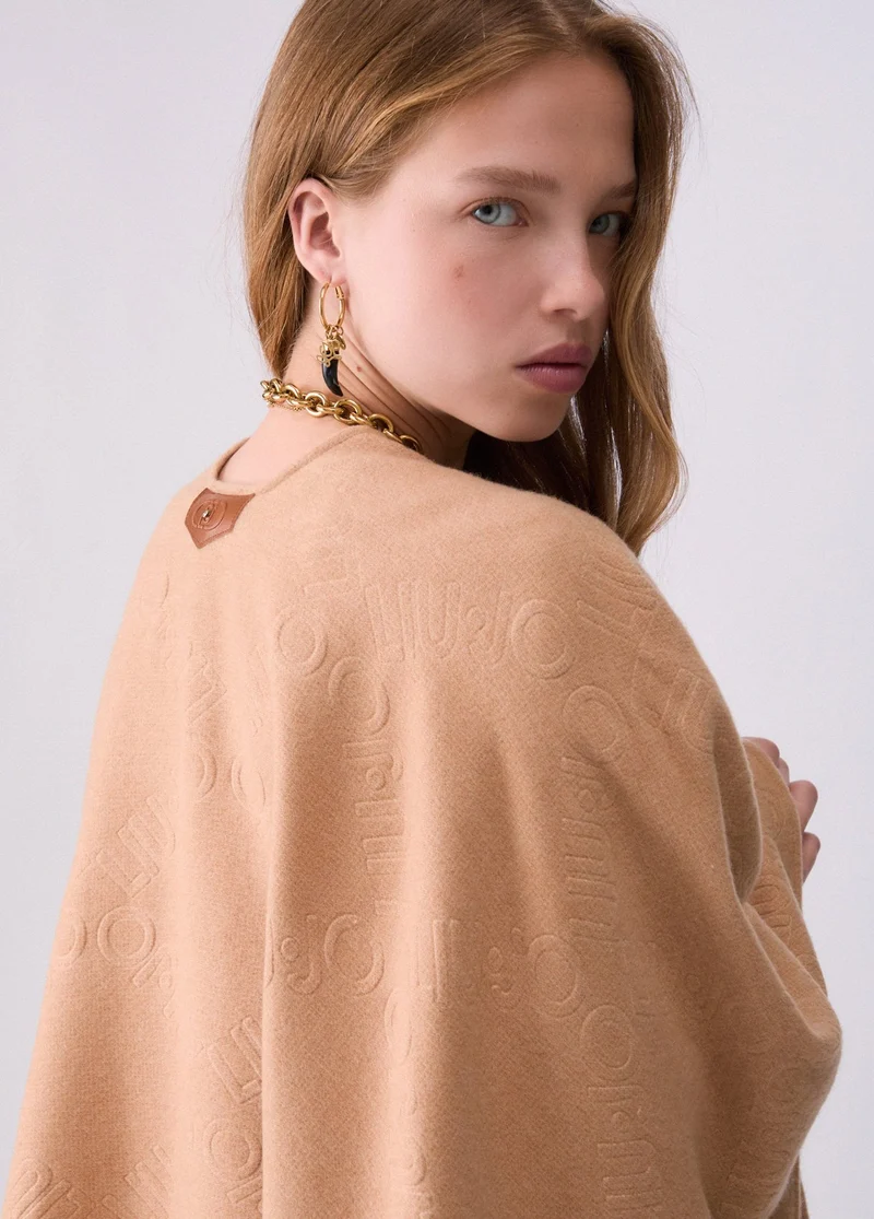 Poncho with embossed logo