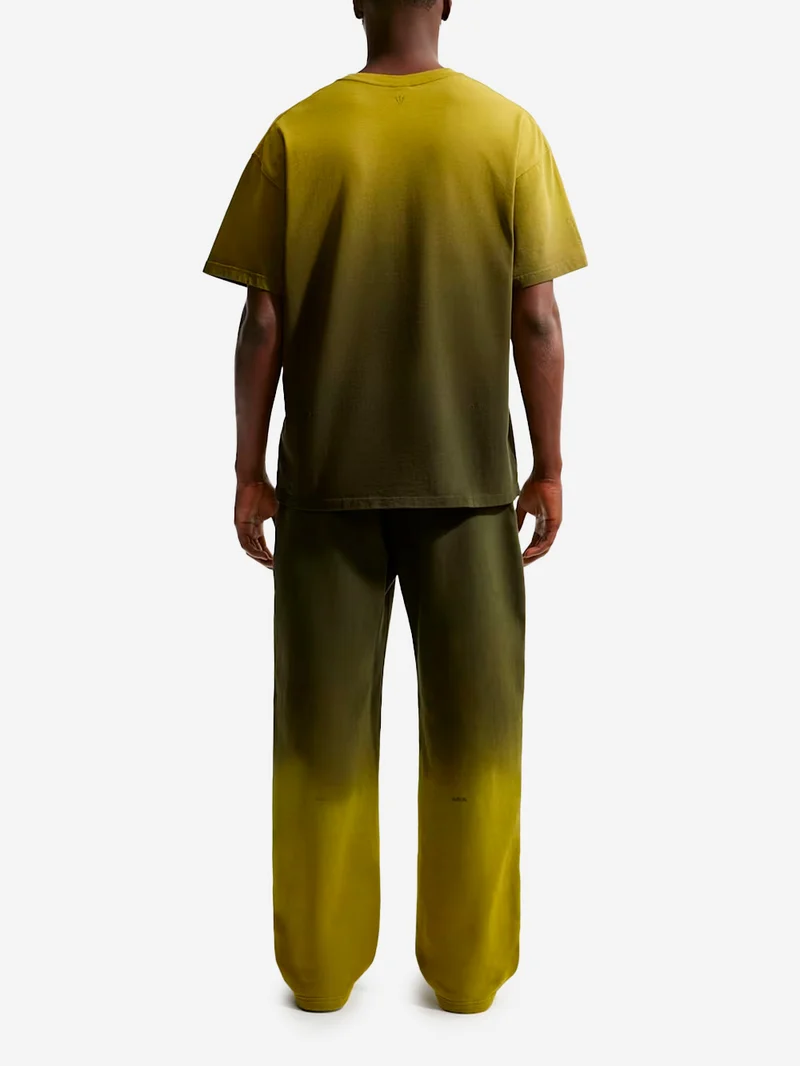 Pantaloni fleece verdi CS Nocta x Drake con bordo aperto