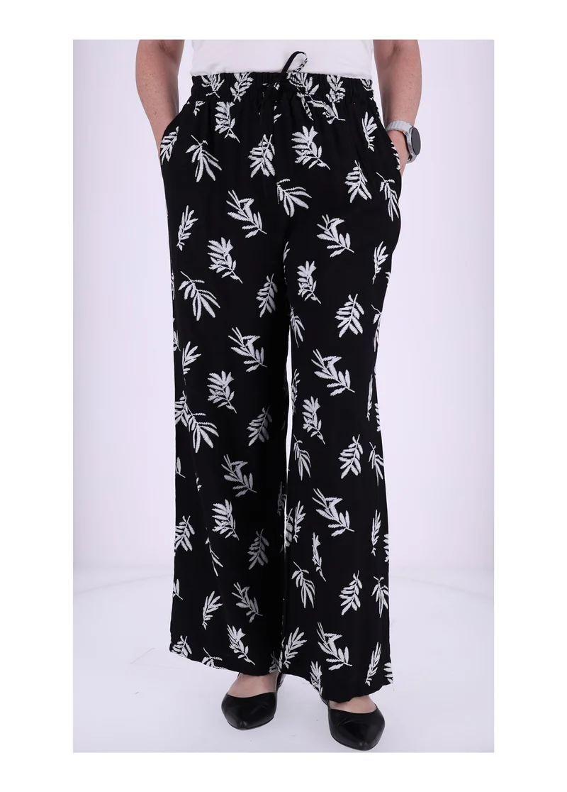 Damen Schlupfhose mit Palmwedel-Print – Schwarz