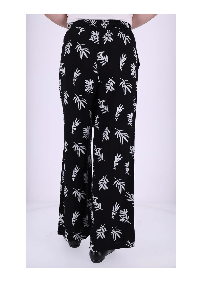 Damen Schlupfhose mit Palmwedel-Print – Schwarz